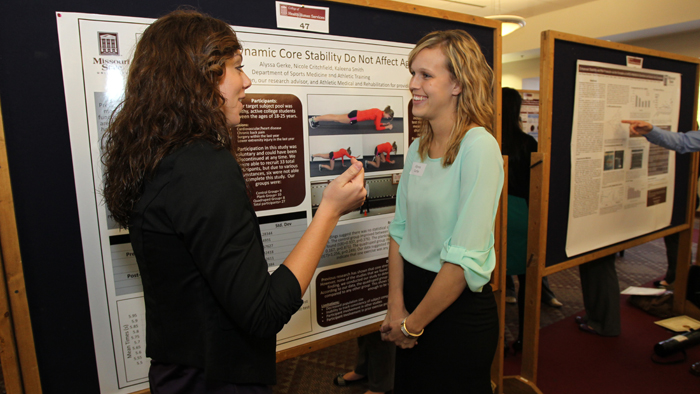 Two students talking at the Graduate Interdisciplinary Forum