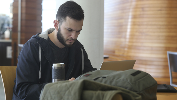 Missouri State University student using laptop at the library